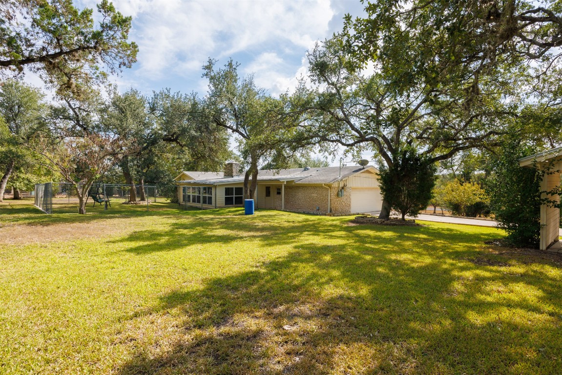 9504 Flintrock Circle Austin, TX 78737 - Photo 26 of 31 a view of a house with swimming pool and a big yard