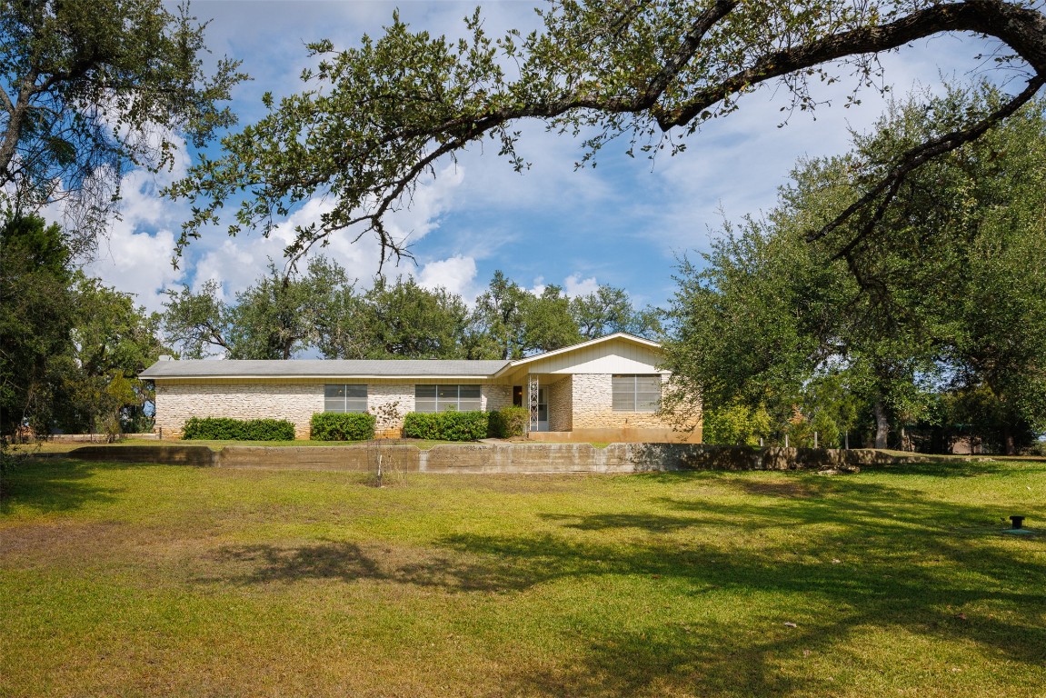 9504 Flintrock Circle Austin, TX 78737 - Photo 27 of 31 a view of a house with a yard