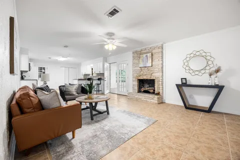 a living room with furniture a fireplace and a flat screen tv