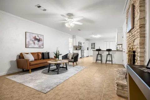 a living room with furniture and kitchen view