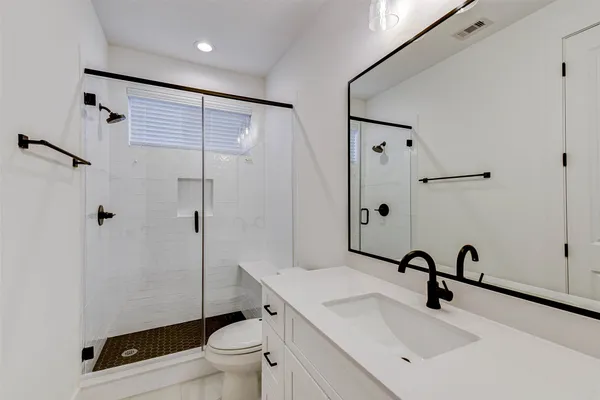 a bathroom with a sink toilet and shower