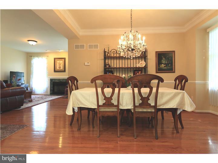 26 Tree Swallow Drive Princeton, NJ 08540 - Photo 3 of 25 a dining room with furniture a chandelier and wooden floor