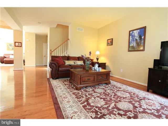 a living room with furniture and a rug