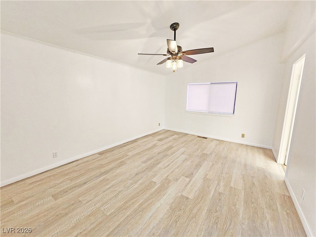 1860 West Wilson Road Pahrump, NV 89048 - Photo 4 of 16 Spare room featuring light wood-style floors, lofted ceiling, and a ceiling fan
