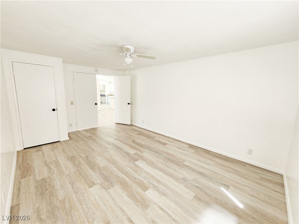 1860 West Wilson Road Pahrump, NV 89048 - Photo 7 of 16 Unfurnished bedroom featuring light wood finished floors and a ceiling fan