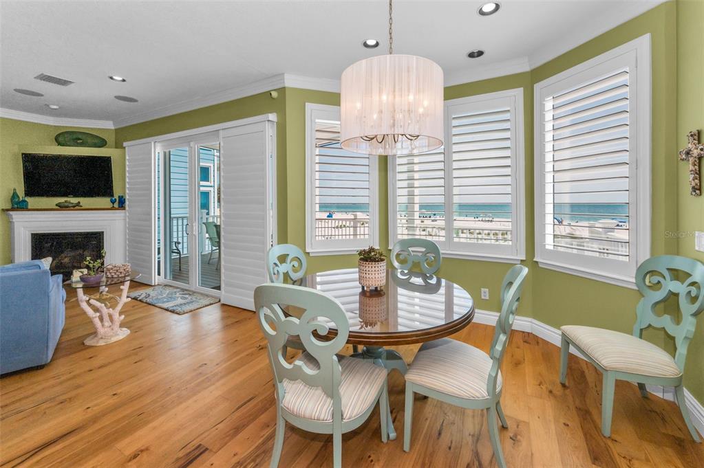13303 Gulf Lane Madeira Beach, FL 33708 - Photo 8 of 42 a view of a dining room with furniture window and wooden floor