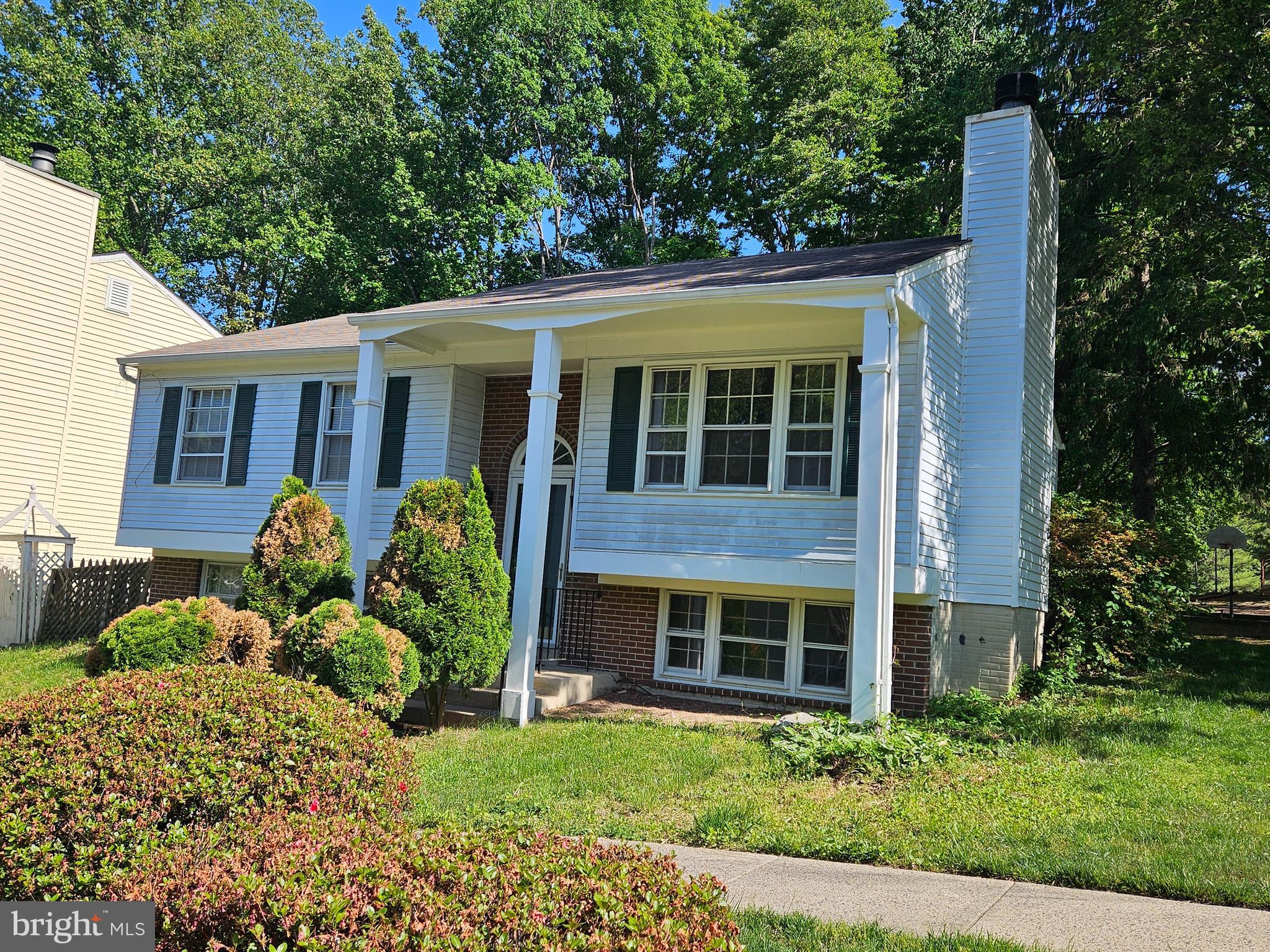 8505 Cherry Heights Court Springfield, VA 22153 - Photo 1 of 2 a front view of a house with garden