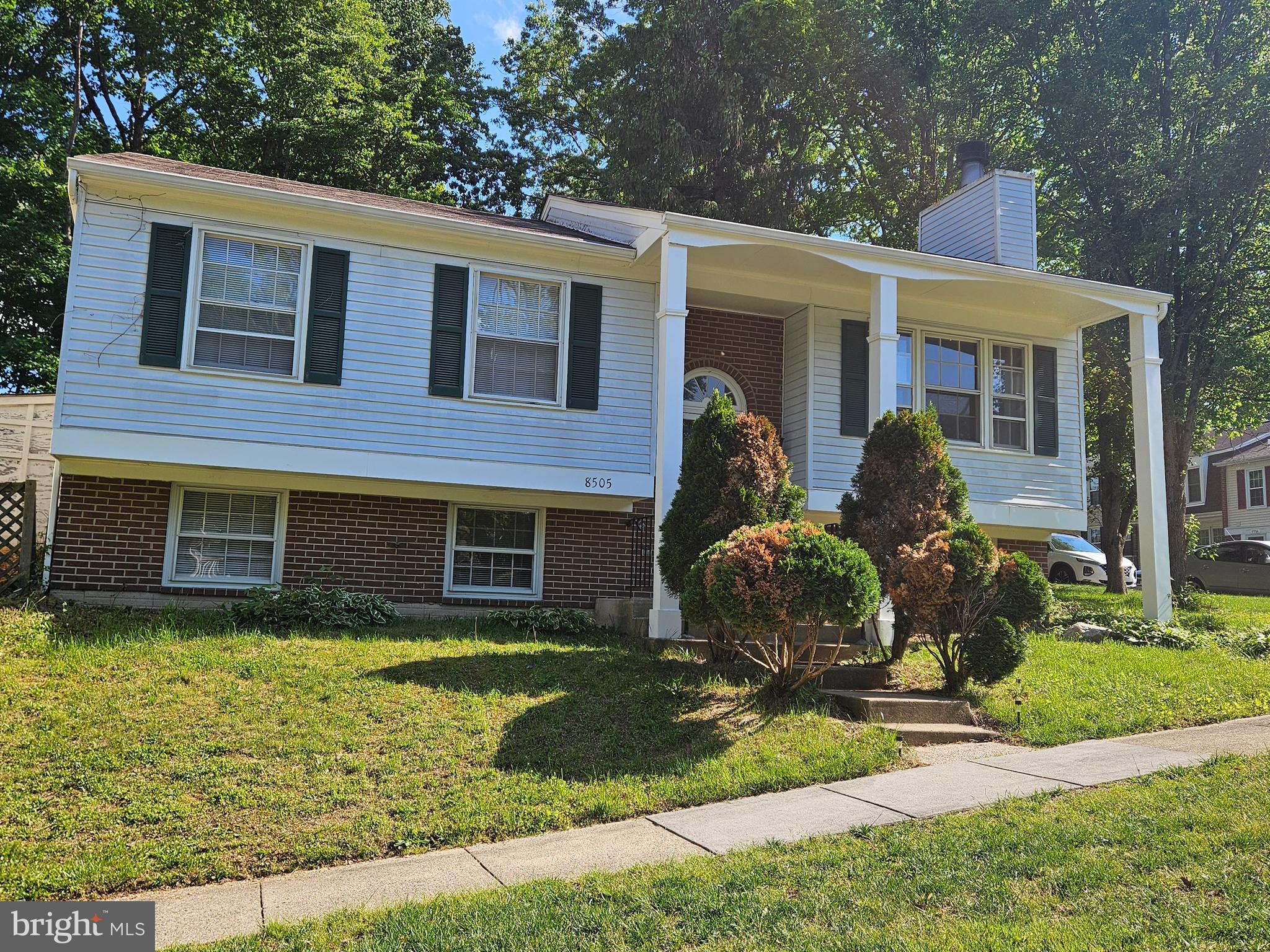 8505 Cherry Heights Court Springfield, VA 22153 - Photo 2 of 2 a front view of a house with garden