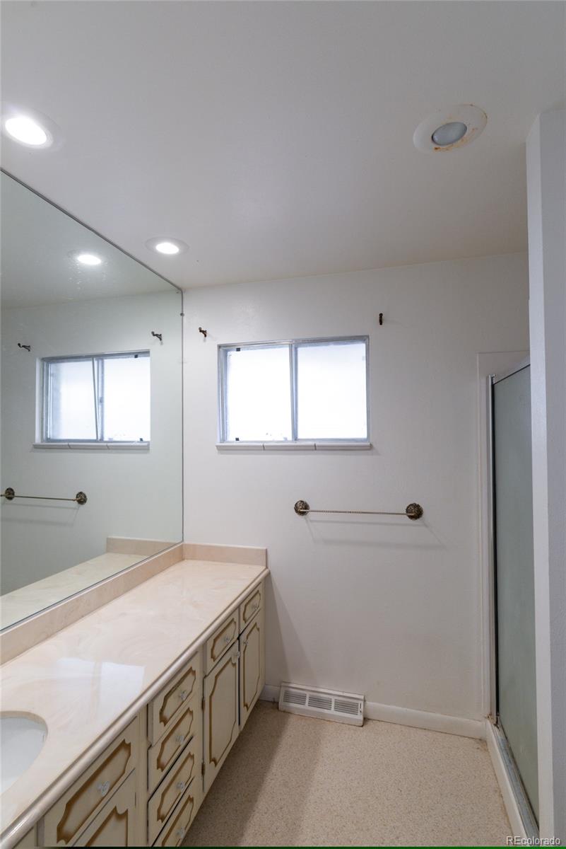 3605 South Oneida Way Denver, CO 80237 - Photo 13 of 24 a bathroom with a sink and mirror