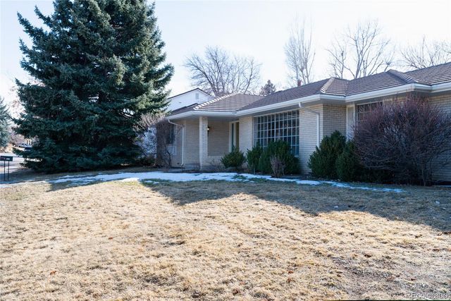 a view of a house with a yard covered in snow