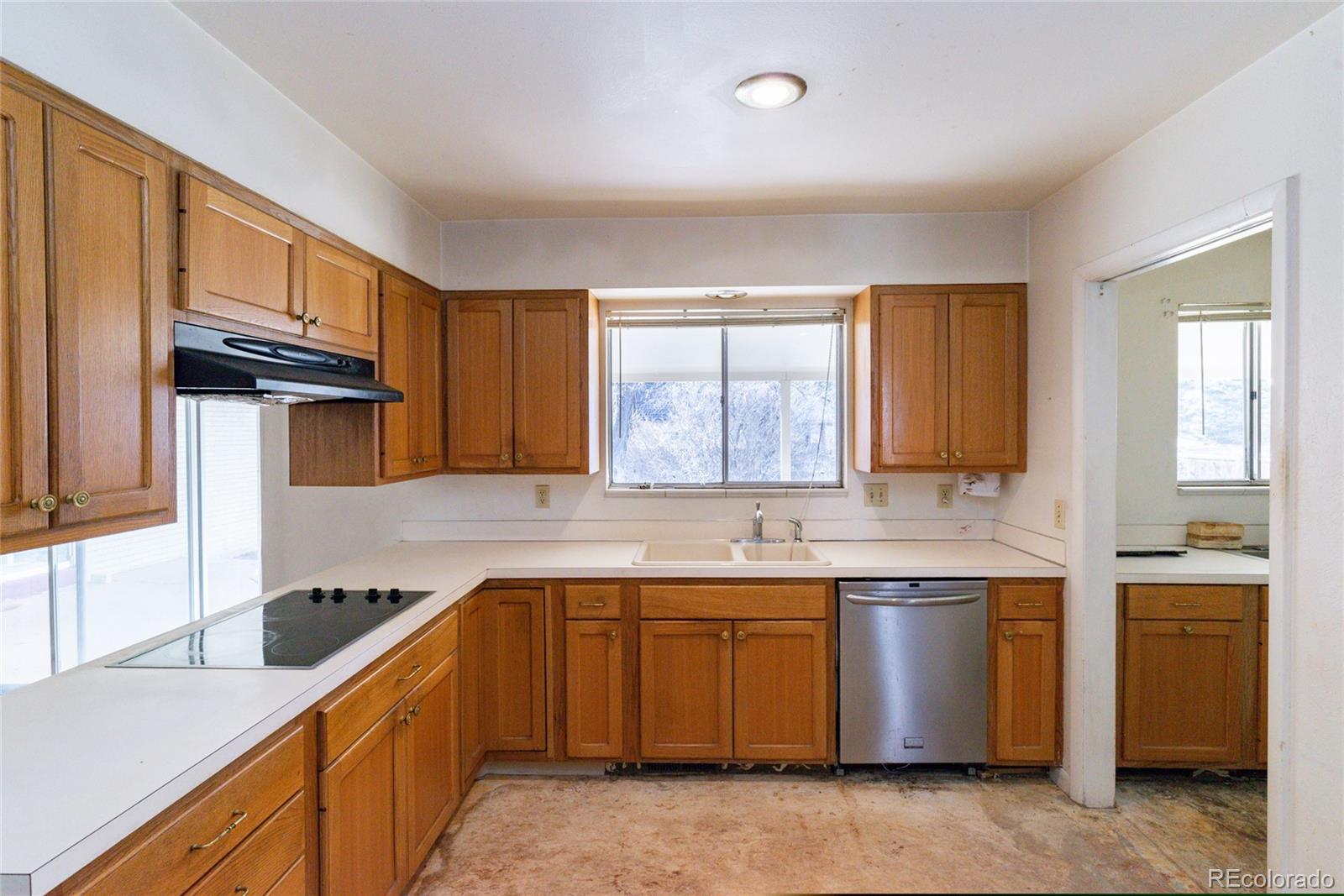 3605 South Oneida Way Denver, CO 80237 - Photo 5 of 24 a kitchen with a sink stove top oven and cabinets