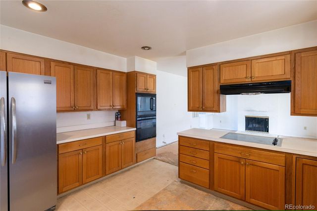 a kitchen with stainless steel appliances granite countertop a refrigerator sink and cabinets