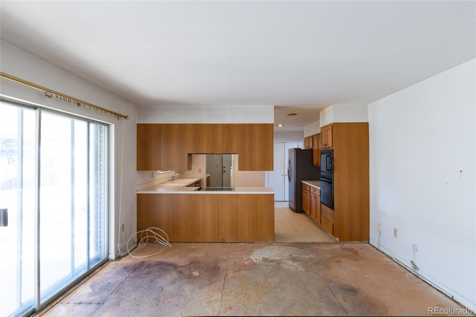 3605 South Oneida Way Denver, CO 80237 - Photo 7 of 24 a view of a kitchen with a refrigerator and a window