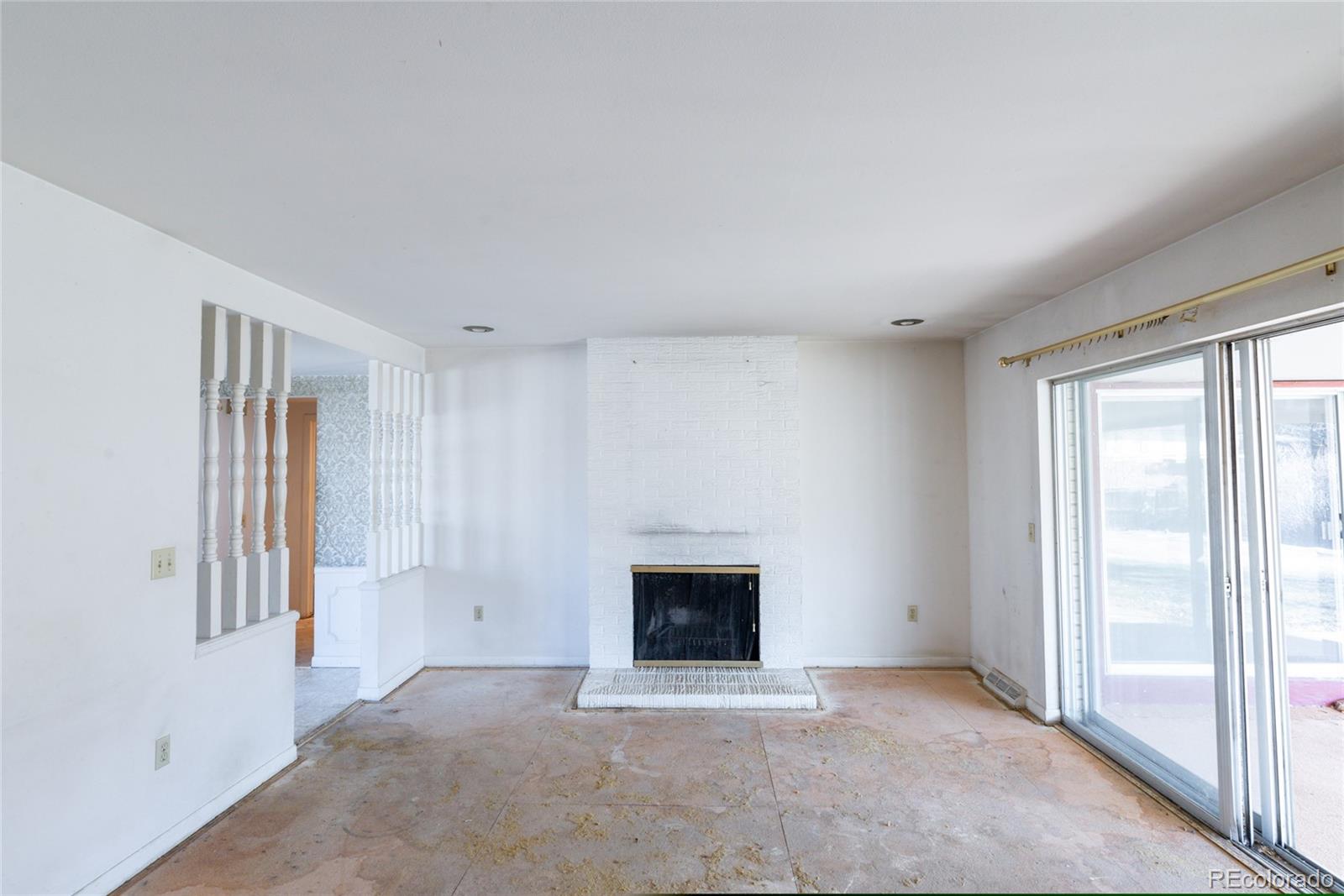 3605 South Oneida Way Denver, CO 80237 - Photo 8 of 24 a view of an empty room with a window and fireplace