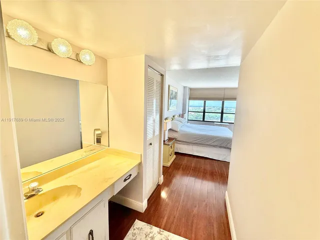 a bathroom with a tub sink and mirror