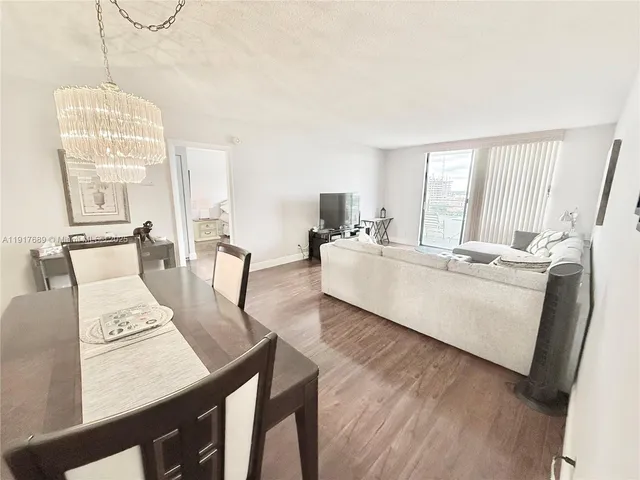 a bedroom with two beds and a large mirror next to a window