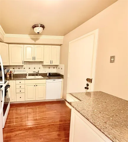 a view of a livingroom with furniture and floor to ceiling window
