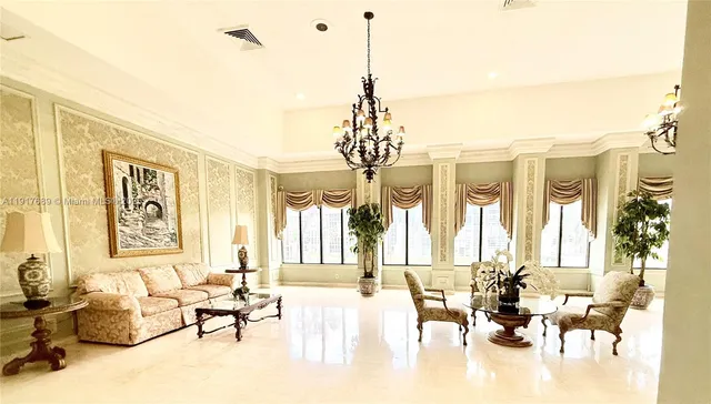 a living room with furniture and a chandelier
