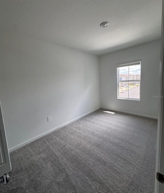 2769 Skyline Loop Kissimmee, FL 34758 - Photo 15 of 17 an empty room with a window