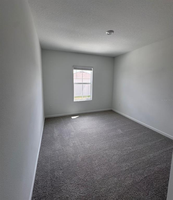 2769 Skyline Loop Kissimmee, FL 34758 - Photo 16 of 17 an empty room with windows
