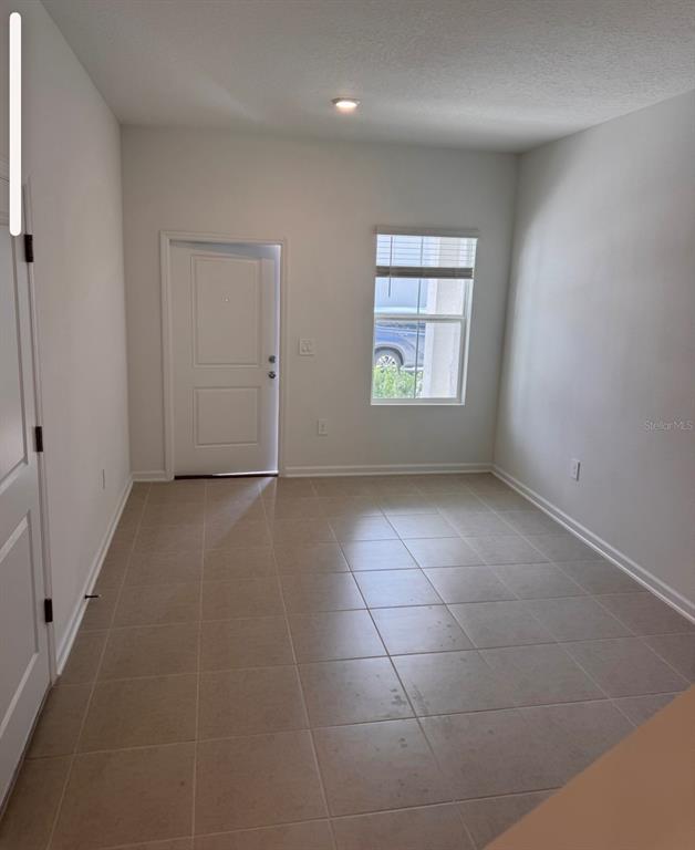 2769 Skyline Loop Kissimmee, FL 34758 - Photo 17 of 17 a view of an empty room with a window