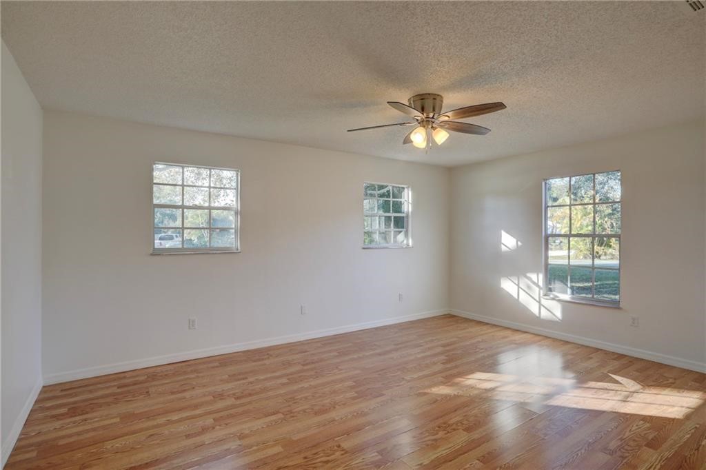 441 Columbus Street Sebastian, FL 32958 - Photo 17 of 35 wooden floor in an empty room with a window