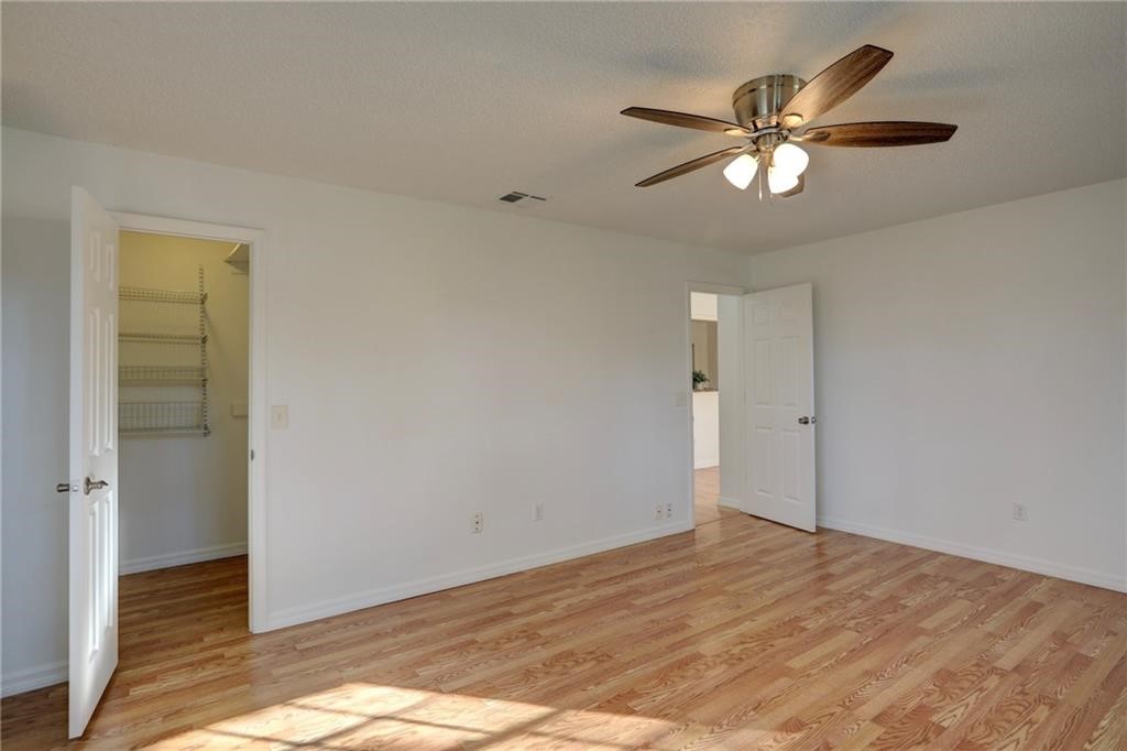 441 Columbus Street Sebastian, FL 32958 - Photo 18 of 35 a view of an empty room with wooden floor and a ceiling fan