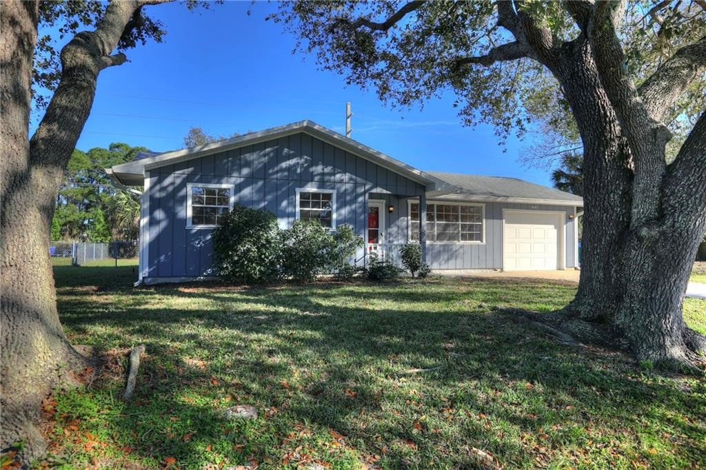 441 Columbus Street Sebastian, FL 32958 - Photo 2 of 35 a front view of a house with a garden