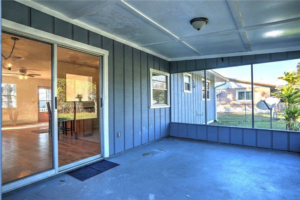 441 Columbus Street Sebastian, FL 32958 - Photo 26 of 35 a view of an empty room with wooden floor and a sliding door