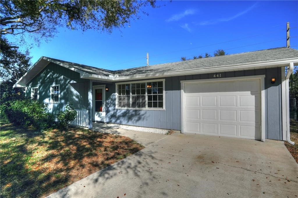 441 Columbus Street Sebastian, FL 32958 - Photo 3 of 35 a front view of a house with a garden