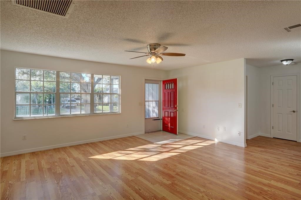 441 Columbus Street Sebastian, FL 32958 - Photo 5 of 35 wooden floor in an empty room with a window