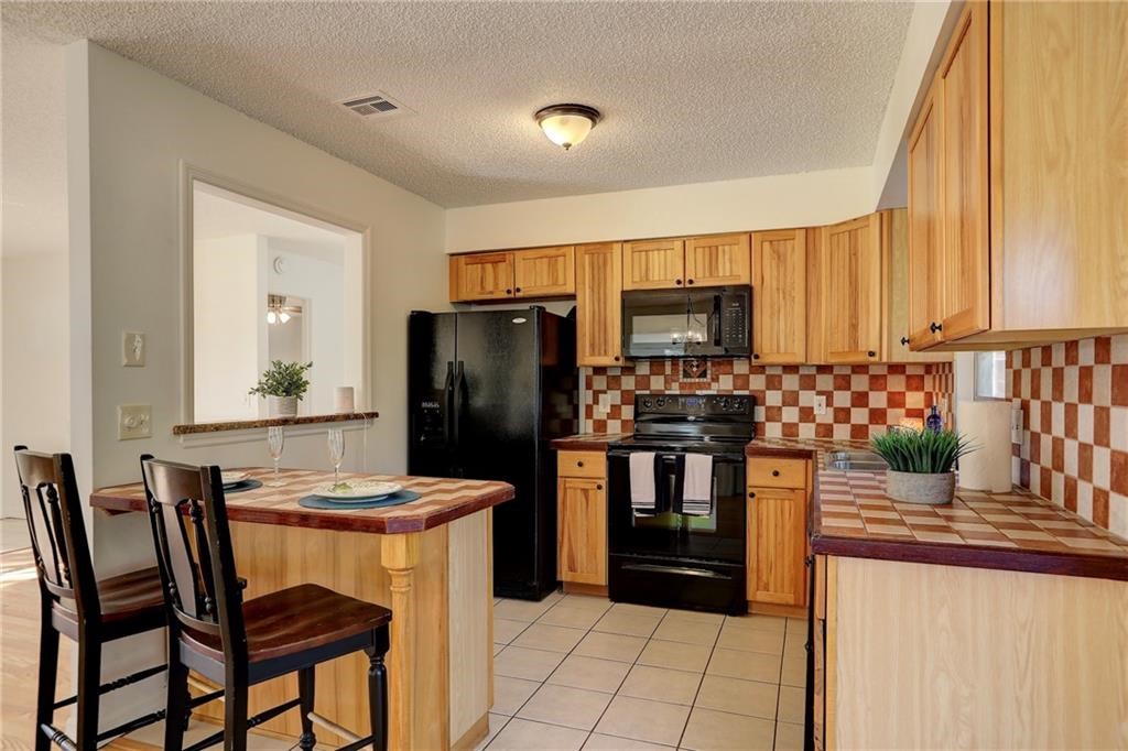 441 Columbus Street Sebastian, FL 32958 - Photo 8 of 35 a kitchen with a refrigerator and microwave