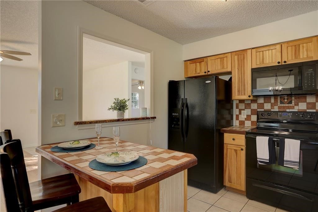 441 Columbus Street Sebastian, FL 32958 - Photo 9 of 35 a kitchen with stainless steel appliances granite countertop a stove a refrigerator and a refrigerator