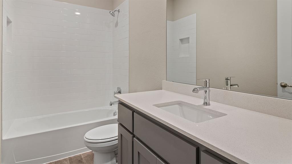 219 Windmill Drive Rhome, TX 76078 - Photo 18 of 29 a bathroom with a sink a toilet and a bathtub