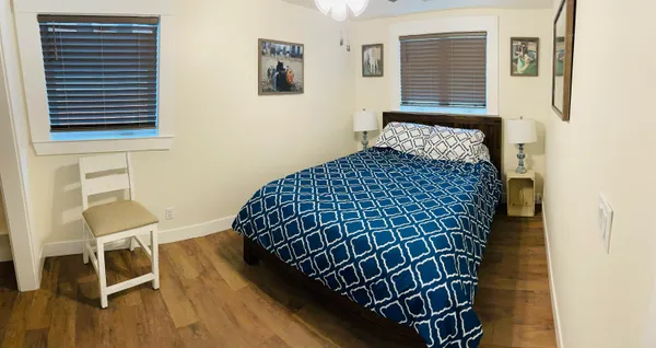 a bedroom with a bed and a chair