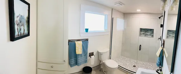a bathroom with a shower and a mirror