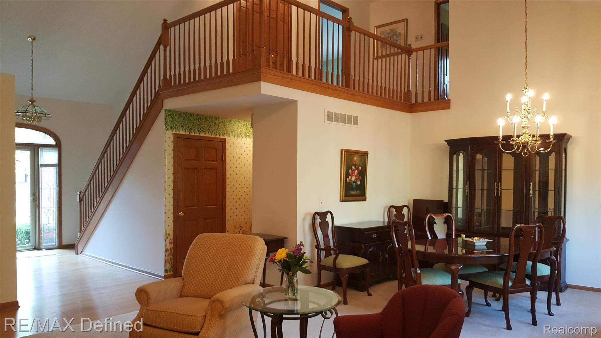 30769 Country Ridge Circle Farmington, MI 48331 - Photo 11 of 31 Large family room, vaulted ceiling with bridge overlooking living/dining area