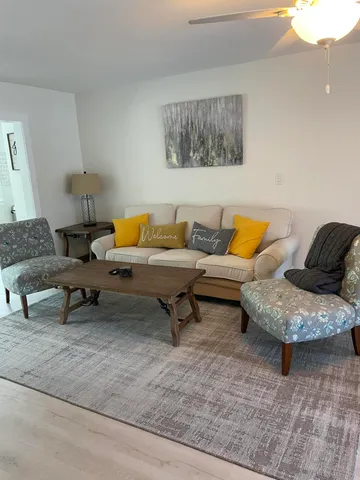a living room with furniture and a lamp