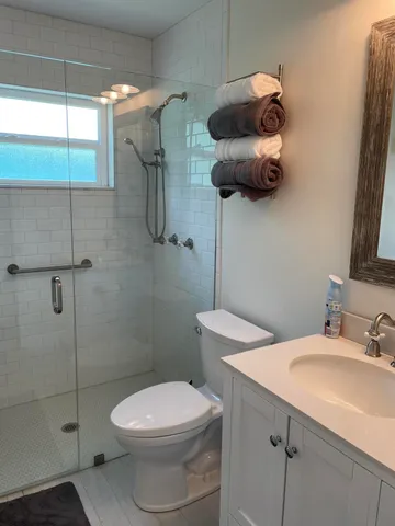 a bathroom with a toilet sink and shower