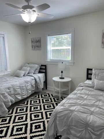 a bedroom with a bed and a table with chair