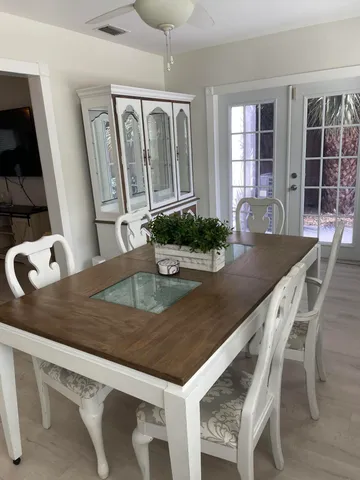 a kitchen with a table chairs and wooden floor