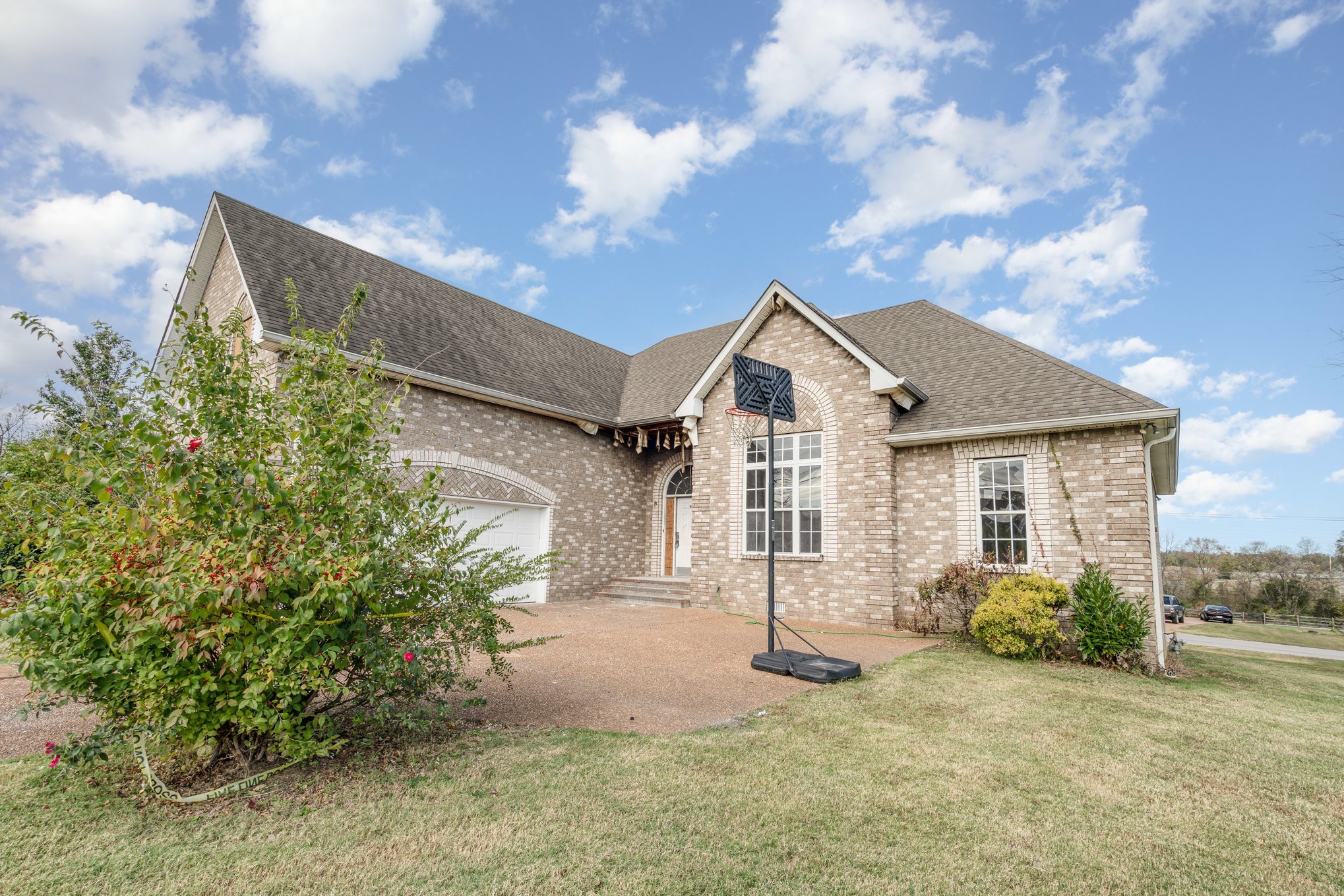 1774 Shagbark Way Gallatin, TN 37066 - Photo 2 of 24 a front view of a house with a yard and garage