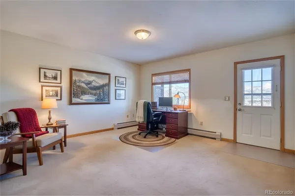 a living room with furniture a window and a piano