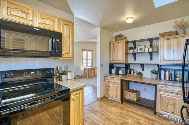 a kitchen with stainless steel appliances granite countertop a stove and cabinets