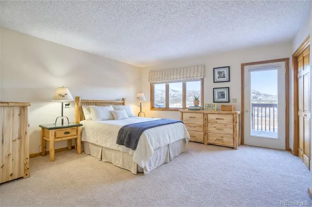 a spacious bedroom with a bed and dresser