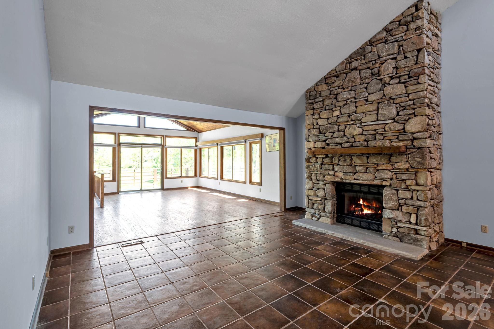 3104 Cove Loop Road Hendersonville, NC 28739 - Photo 12 of 40 an empty room with windows and fireplace
