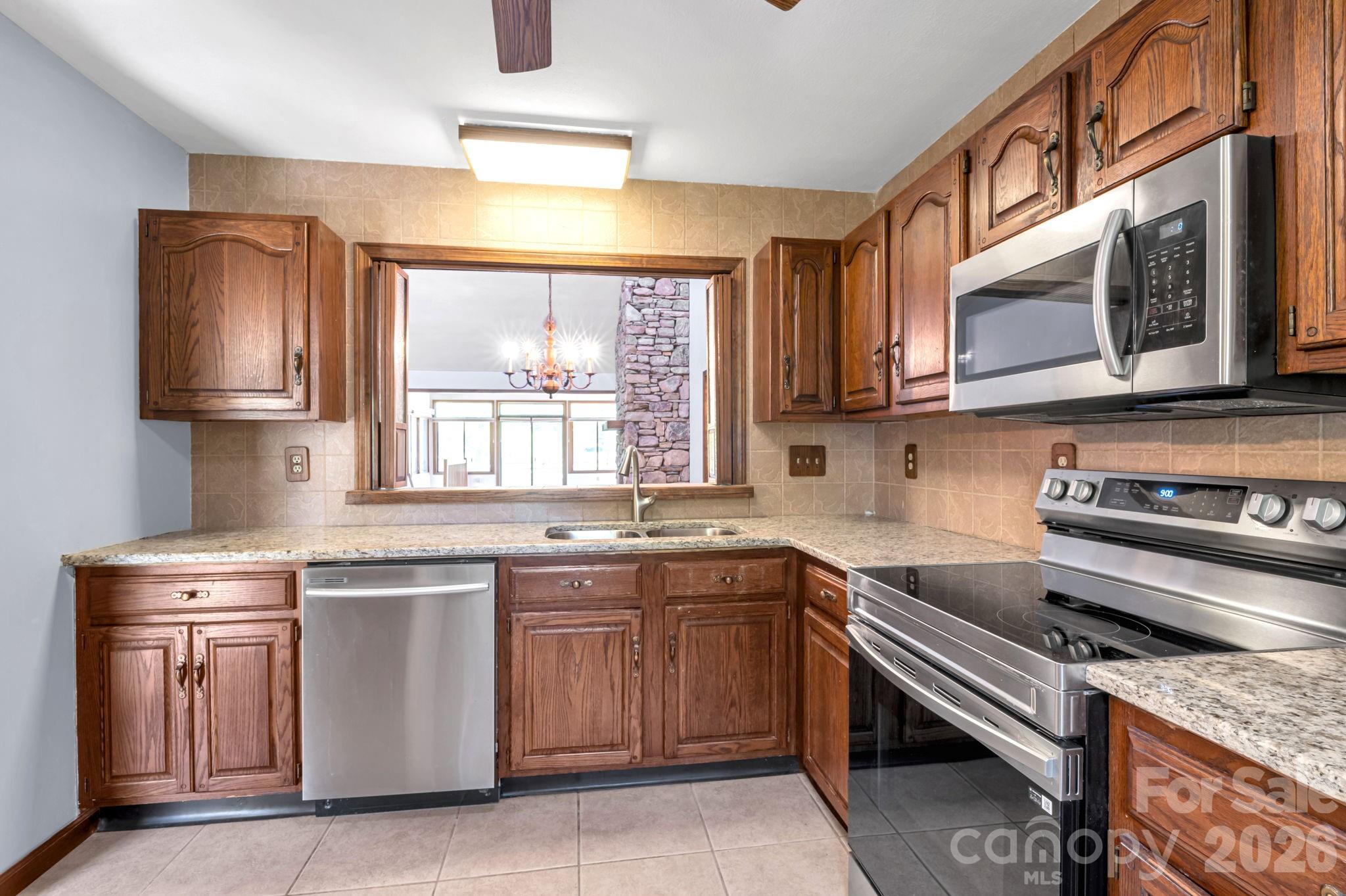 3104 Cove Loop Road Hendersonville, NC 28739 - Photo 17 of 40 a kitchen with a sink stove and microwave