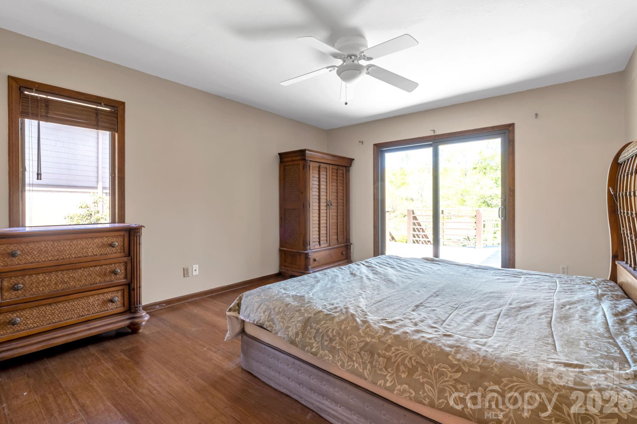 3104 Cove Loop Road Hendersonville, NC 28739 - Photo 20 of 40 a bedroom with a bed and a window
