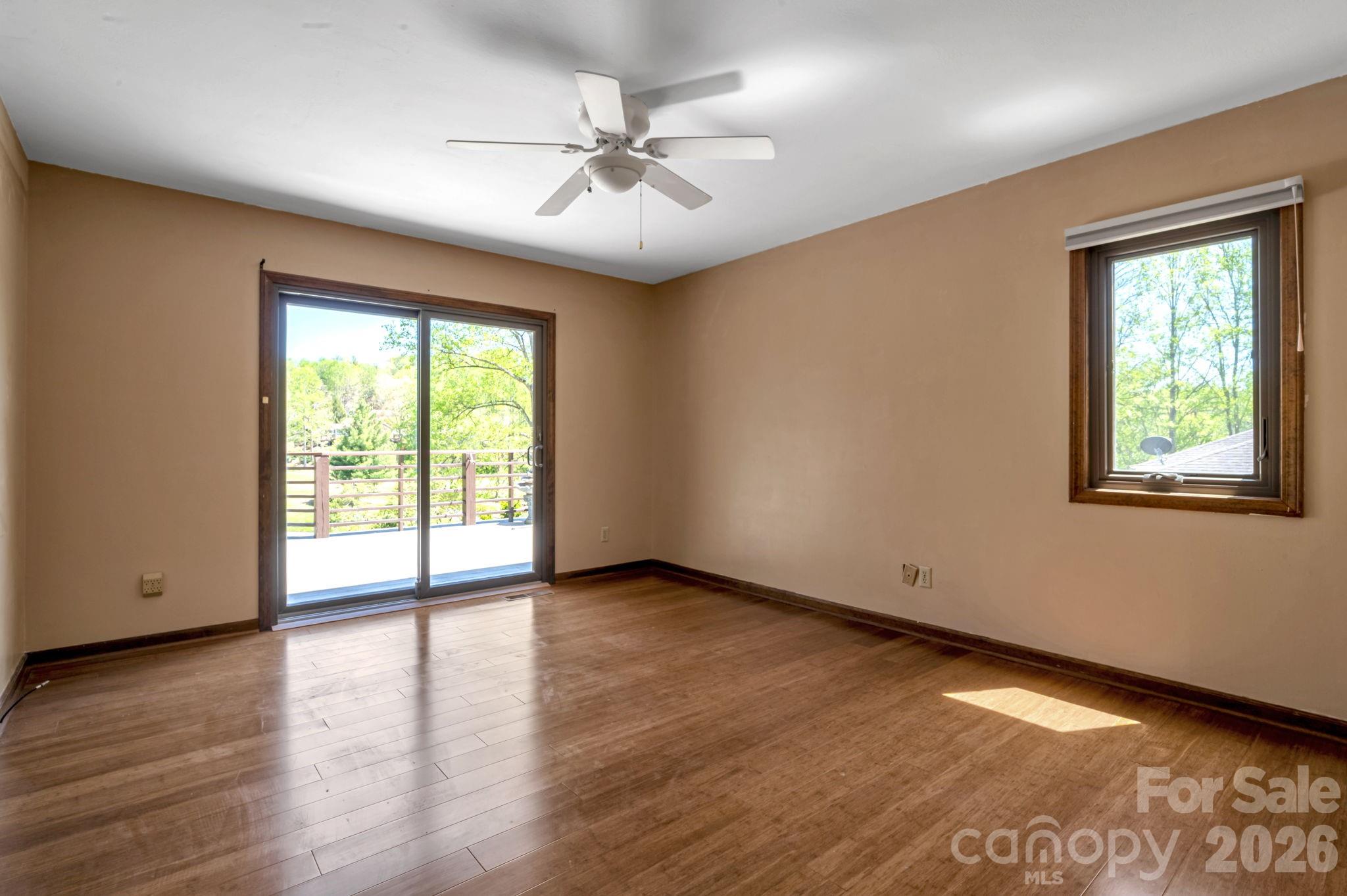 3104 Cove Loop Road Hendersonville, NC 28739 - Photo 25 of 40 a view of an empty room with wooden floor and a window