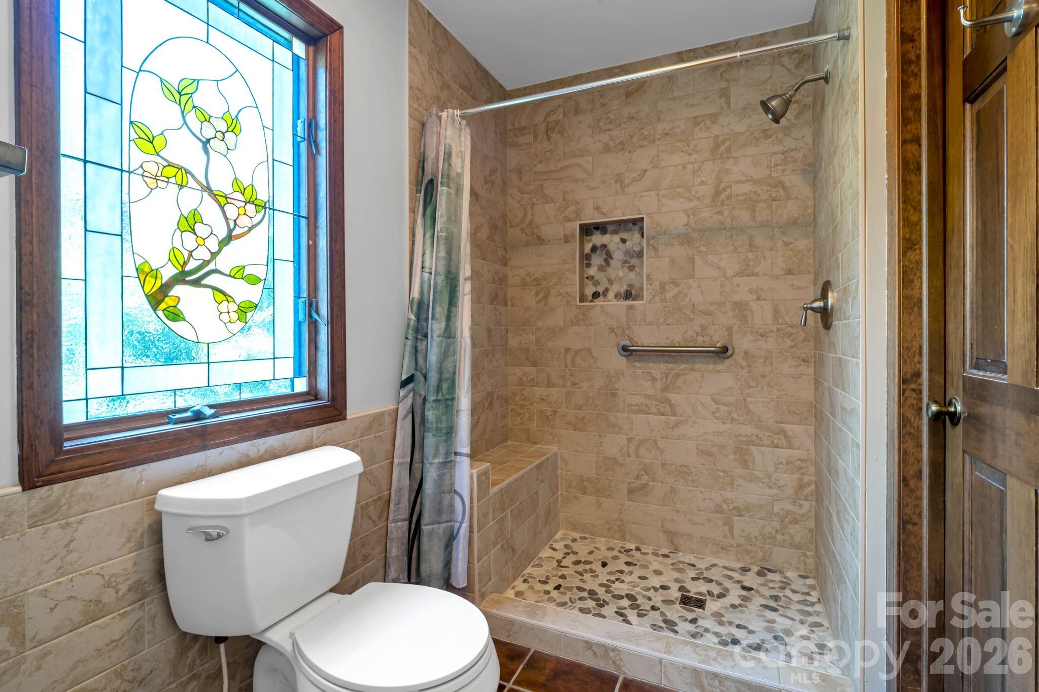 3104 Cove Loop Road Hendersonville, NC 28739 - Photo 27 of 40 a bathroom with a toilet and a shower